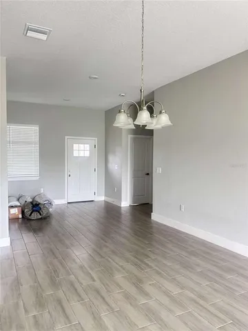 a view of a livingroom with hardwood floor and a ceiling fan