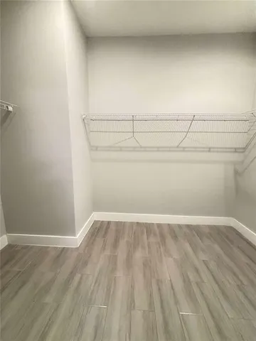 a view of a room with wooden floor