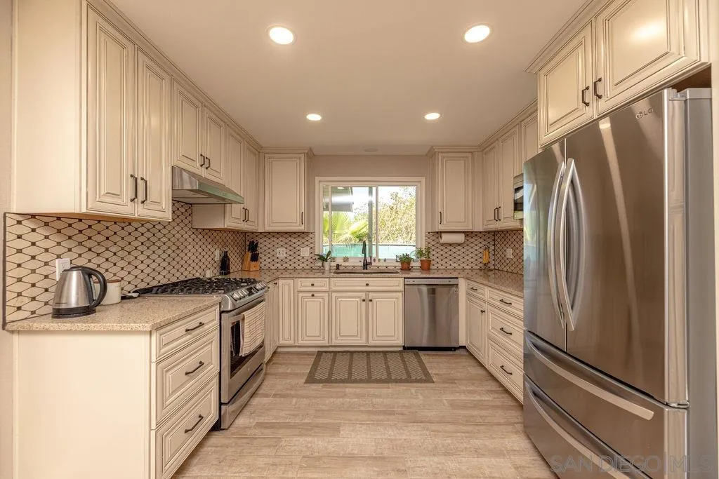 12317 Witt Road Poway, CA 92064 - Photo 13 of 43 a kitchen with stainless steel appliances granite countertop a refrigerator sink and stove