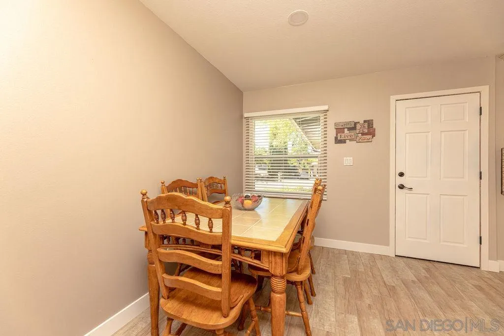 12317 Witt Road Poway, CA 92064 - Photo 17 of 43 a view of a dining room with furniture and wooden floor