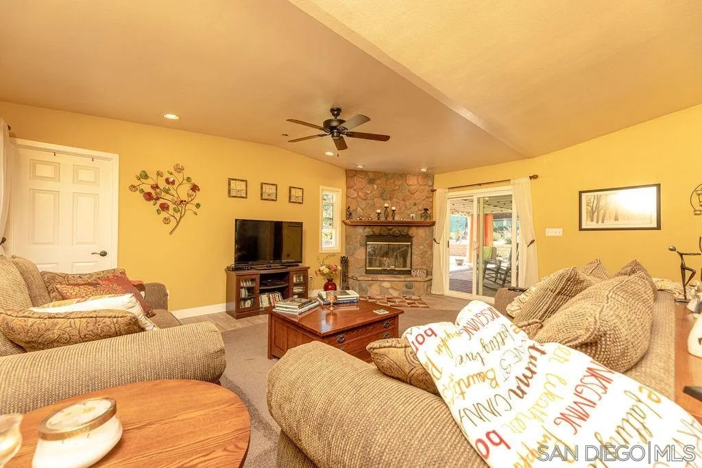 12317 Witt Road Poway, CA 92064 - Photo 19 of 43 a living room with furniture fireplace and a flat screen tv