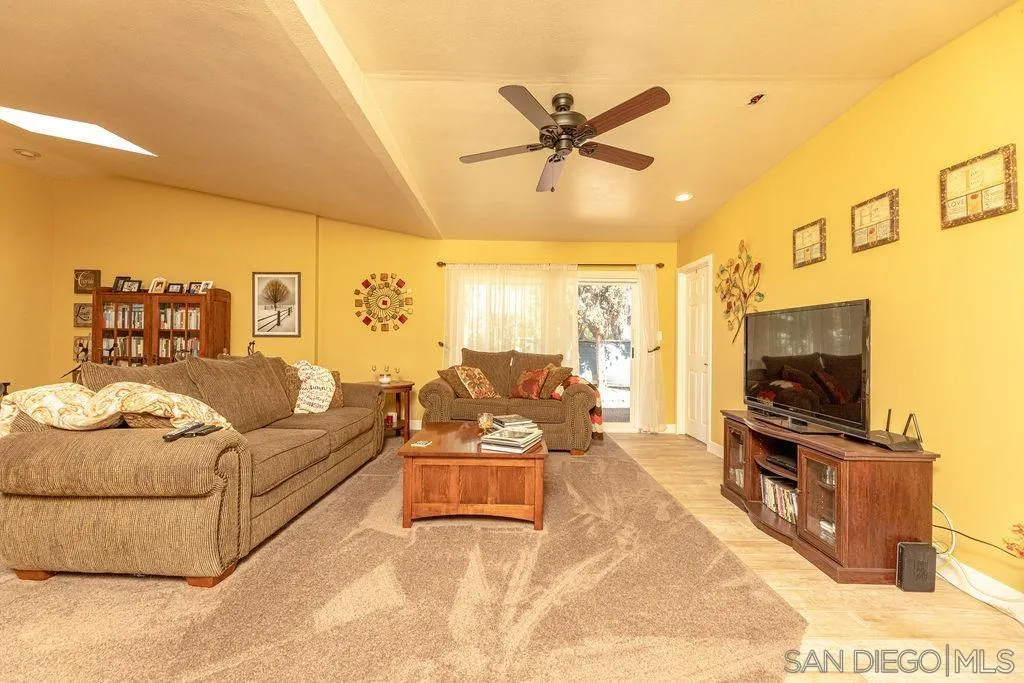 12317 Witt Road Poway, CA 92064 - Photo 20 of 43 a living room with furniture and a flat screen tv