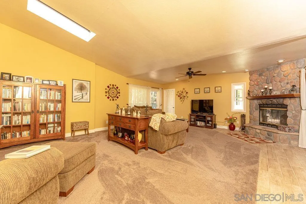 12317 Witt Road Poway, CA 92064 - Photo 21 of 43 a living room with furniture a fireplace and a flat screen tv