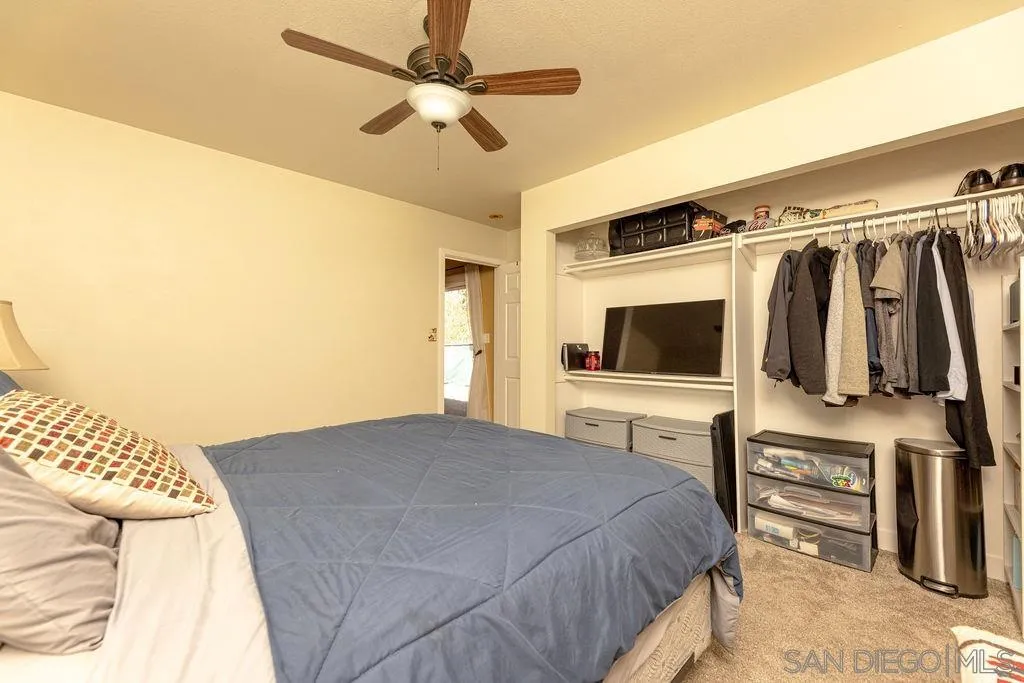 12317 Witt Road Poway, CA 92064 - Photo 25 of 43 a bedroom with a bed and a flat screen tv