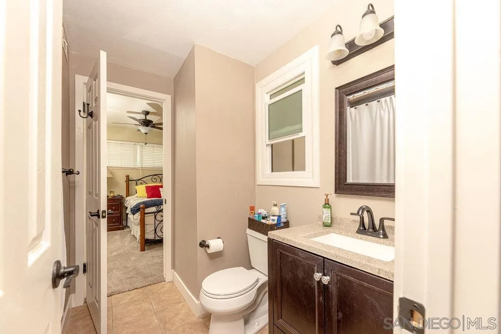 12317 Witt Road Poway, CA 92064 - Photo 26 of 43 a bathroom with a granite countertop sink toilet and shower