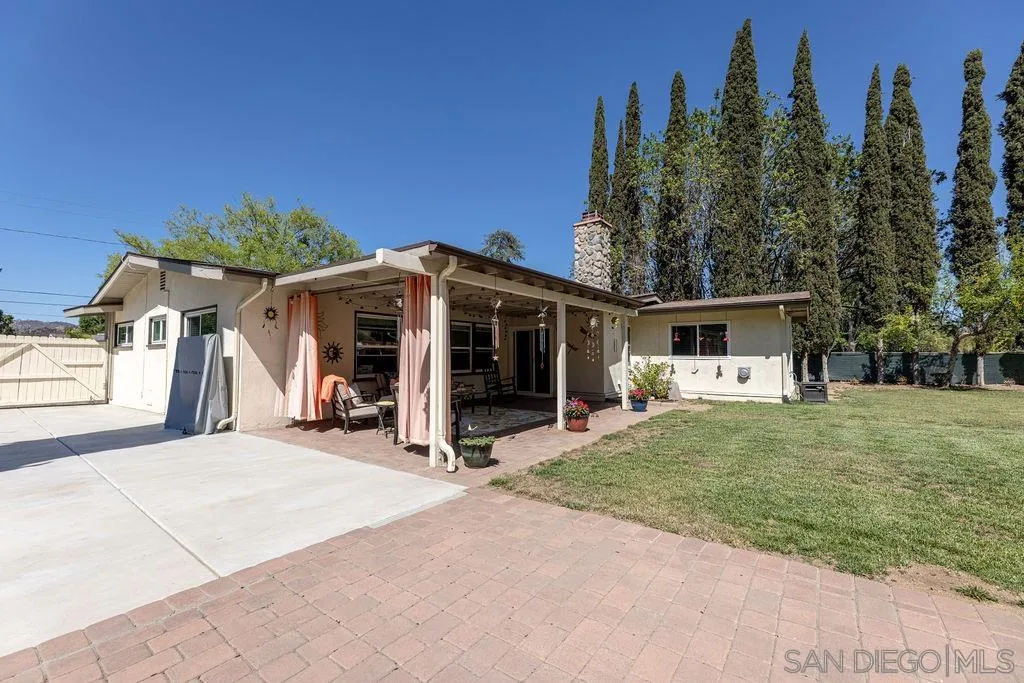 12317 Witt Road Poway, CA 92064 - Photo 3 of 43 a front view of a house with a yard and trees
