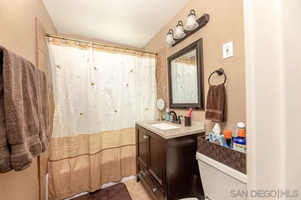 12317 Witt Road Poway, CA 92064 - Photo 31 of 43 a bathroom with a double vanity sink mirror and shower