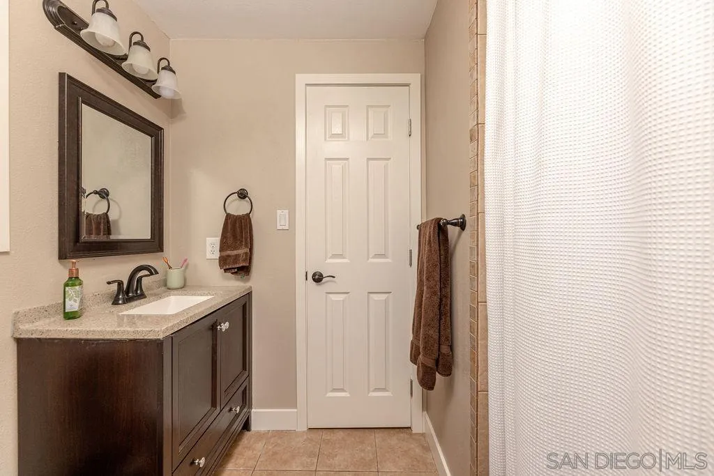 12317 Witt Road Poway, CA 92064 - Photo 37 of 43 a en suite bathroom with a sink and mirror