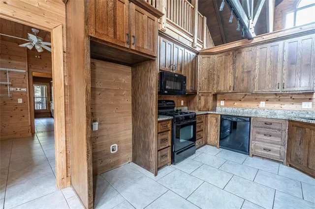 a kitchen with stainless steel appliances granite countertop a refrigerator and a stove