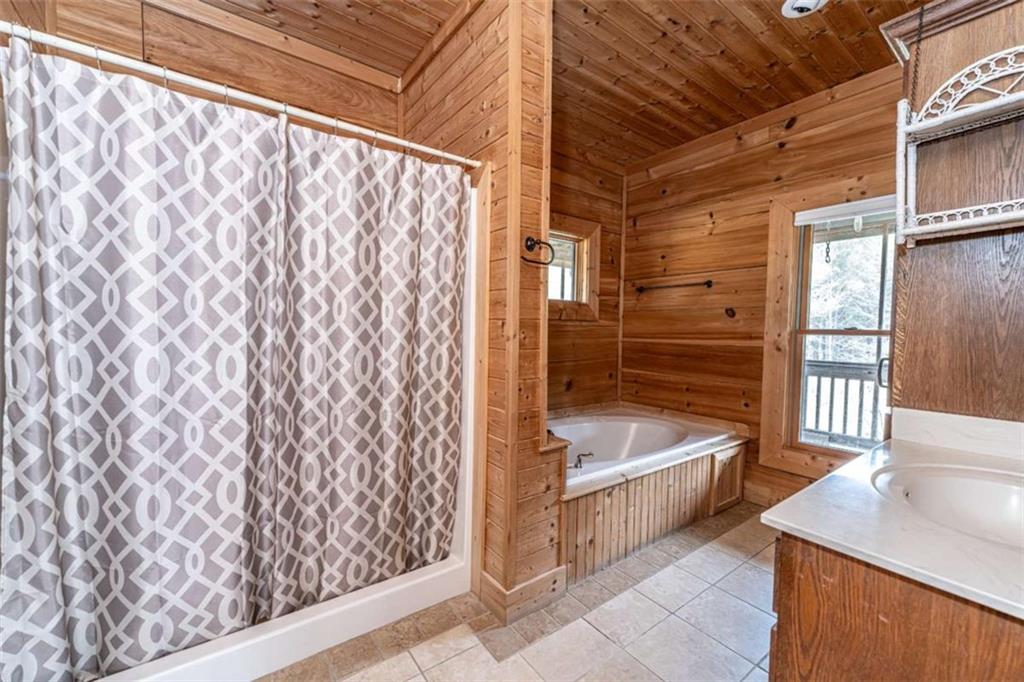 1863 New Rosedale Road Northeast Armuchee, GA 30105 - Photo 20 of 43 a bathroom with a tub a sink and a shower