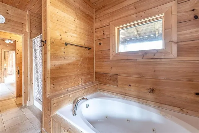 a bathroom with a tub and shower