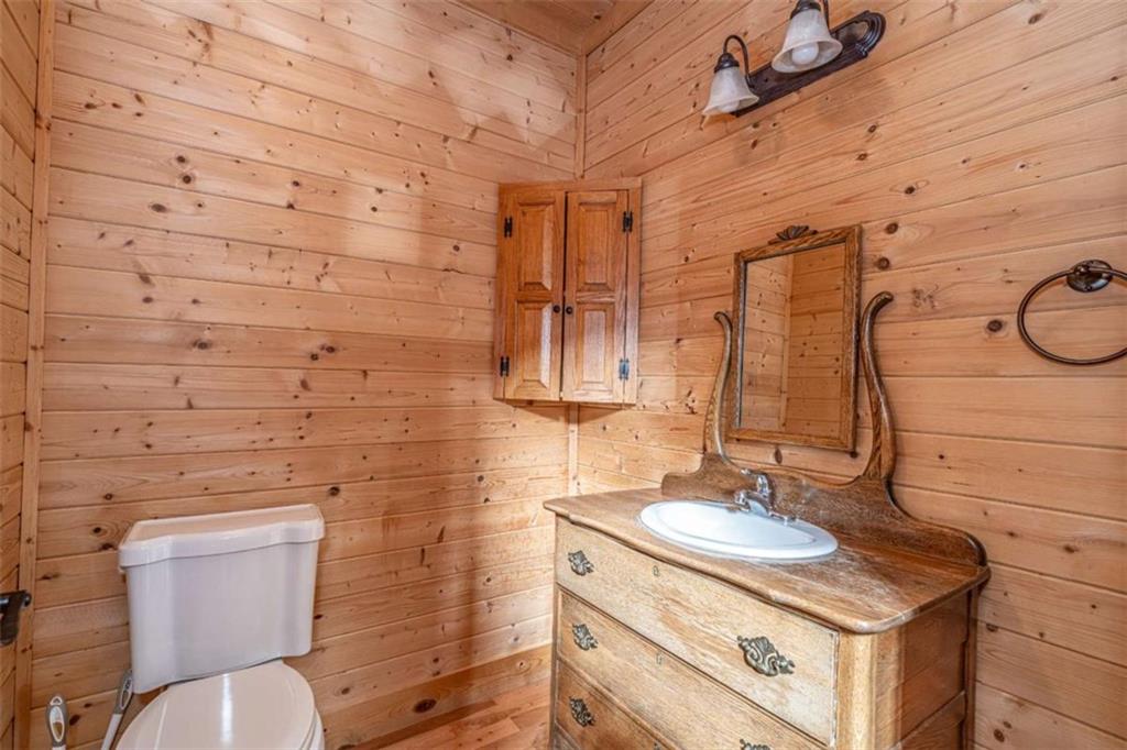 1863 New Rosedale Road Northeast Armuchee, GA 30105 - Photo 26 of 43 a bathroom with a granite countertop toilet sink and mirror