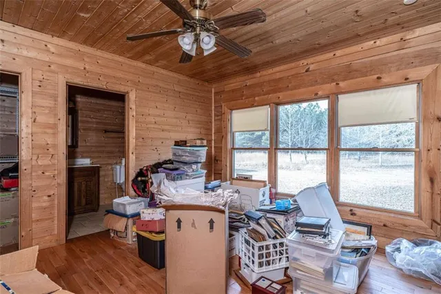 a living room with furniture a flat screen tv and a large window