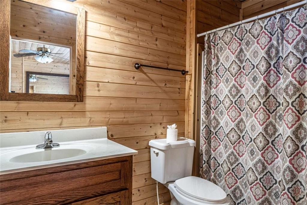 1863 New Rosedale Road Northeast Armuchee, GA 30105 - Photo 28 of 43 a bathroom with a sink a toilet and shower curtain