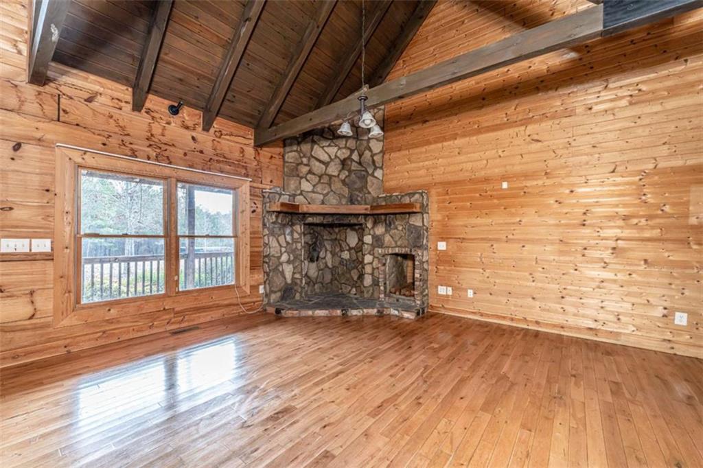 1863 New Rosedale Road Northeast Armuchee, GA 30105 - Photo 6 of 43 a view of an empty room with wooden floor and a fireplace
