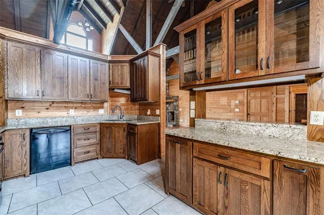 a kitchen with stainless steel appliances granite countertop a sink and cabinets