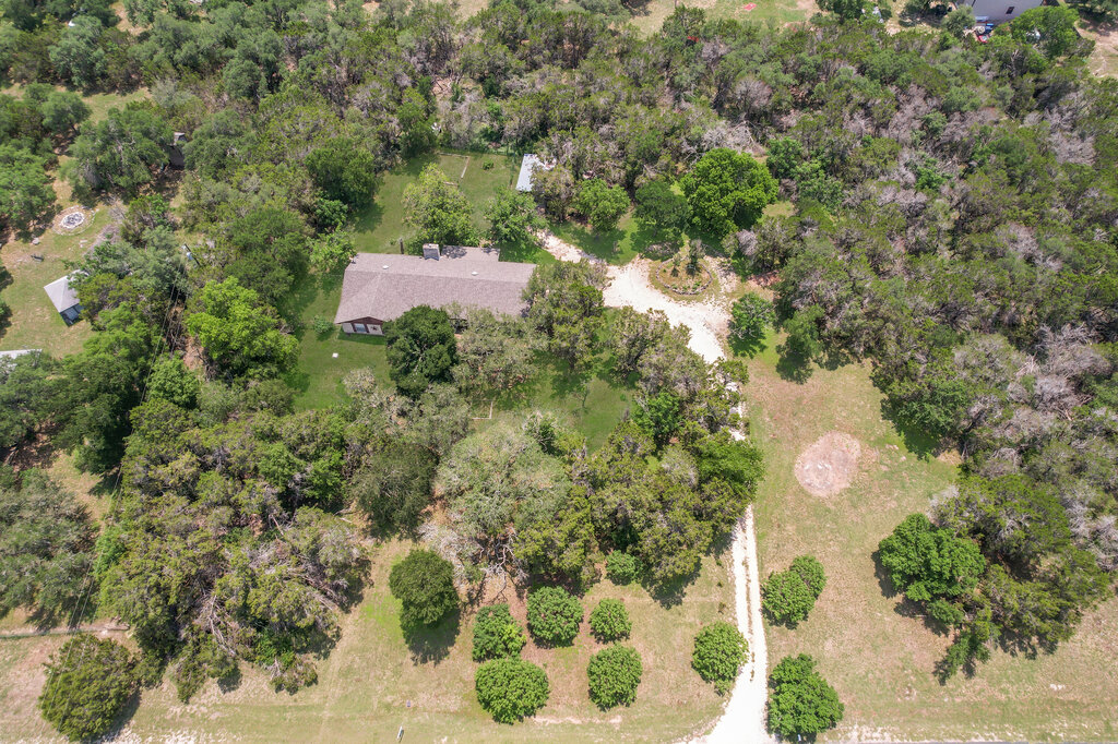 301 Navajo Trail Georgetown, TX 78633 - Photo 3 of 35 a view of a yard with plants and large trees