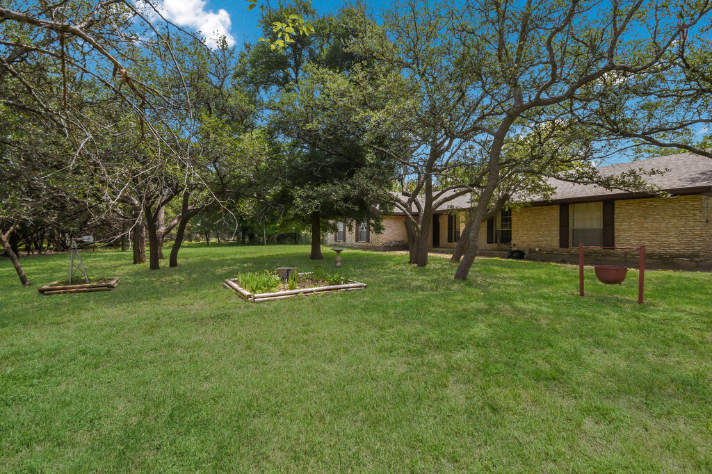 301 Navajo Trail Georgetown, TX 78633 - Photo 10 of 35 a view of a house with a backyard