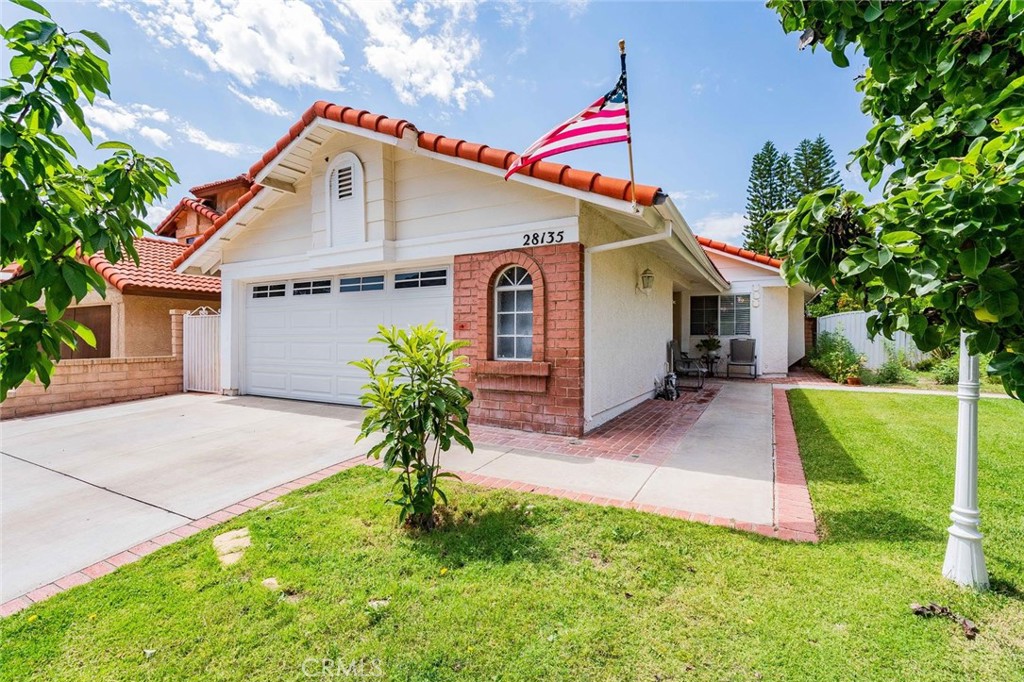 28135 Wildwind Road Canyon Country, CA 91351 - Photo 1 of 1 a front view of house with yard and green space