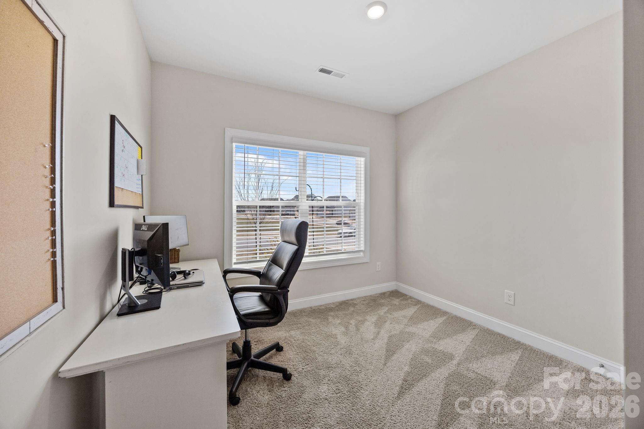 181 Brixham Loop Troutman, NC 28166 - Photo 17 of 28 a view of a workspace with furniture and a window