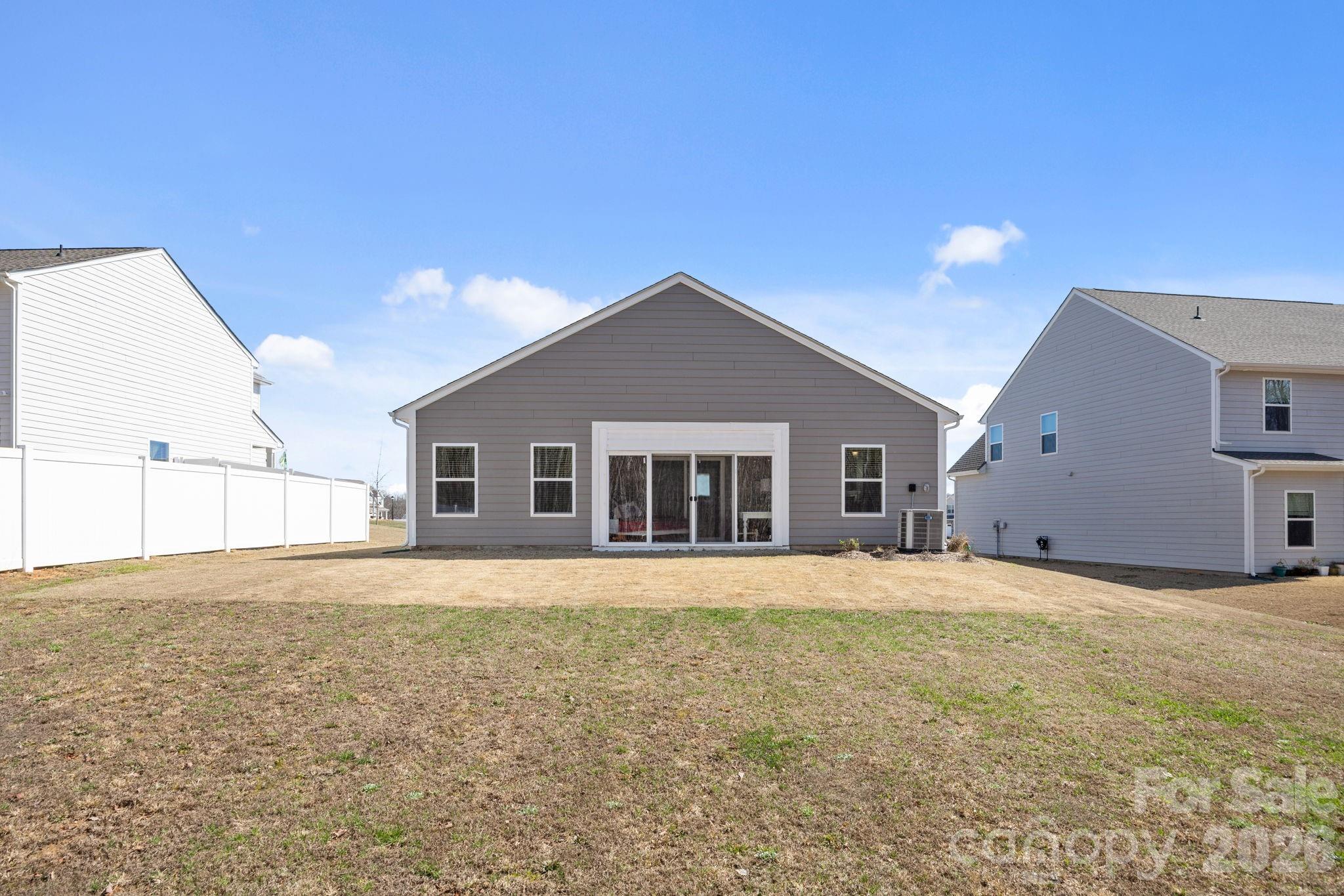 181 Brixham Loop Troutman, NC 28166 - Photo 23 of 28 a big house with a big yard and large trees