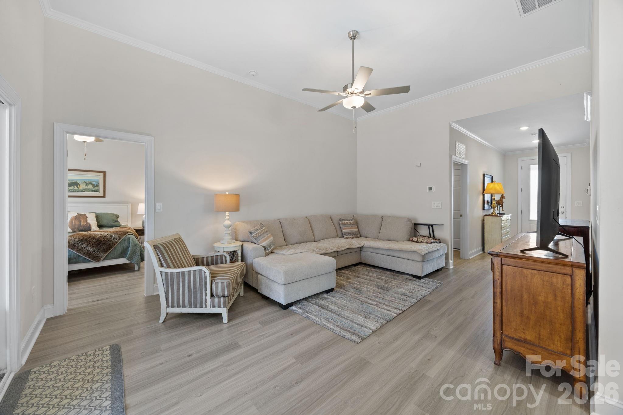 181 Brixham Loop Troutman, NC 28166 - Photo 4 of 28 a living room with furniture and wooden floor