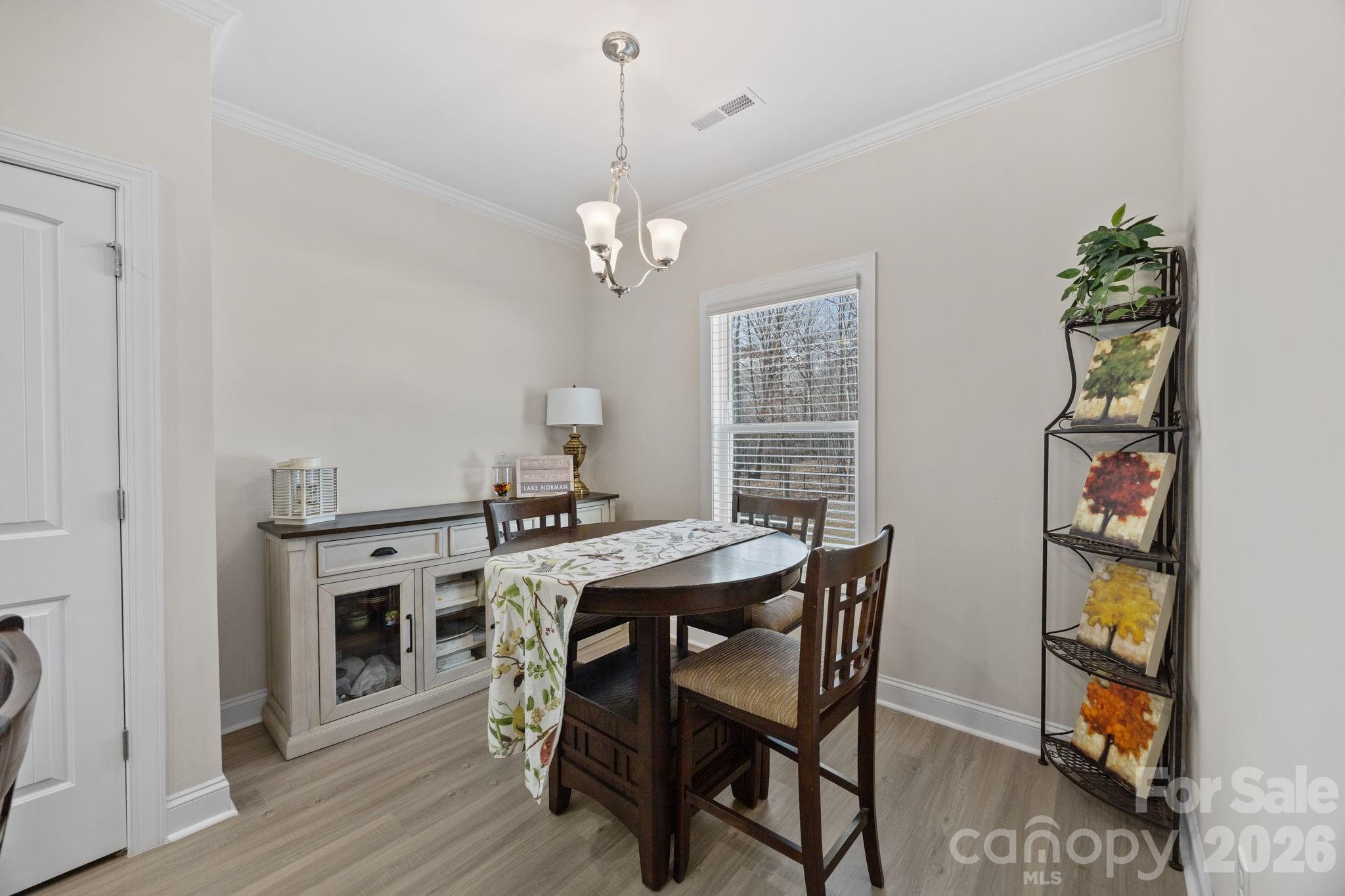 181 Brixham Loop Troutman, NC 28166 - Photo 10 of 28 a view of a dining room with furniture and wooden floor