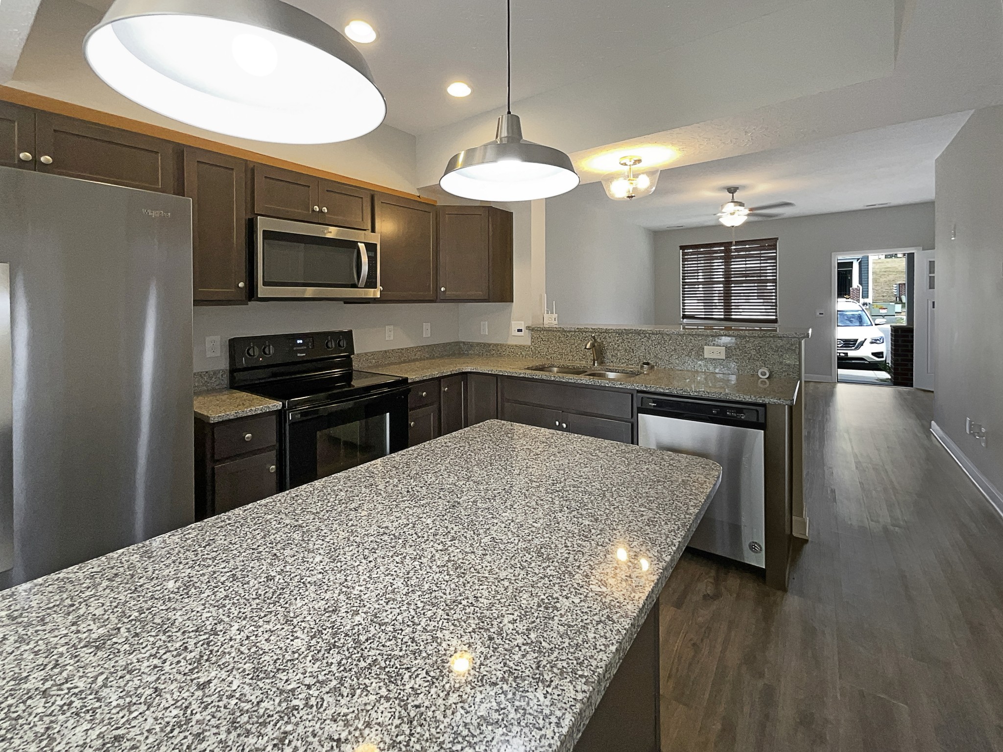 1382 Rural Hill Road, Unit 364 Antioch, TN 37013 - Photo 7 of 22 a kitchen with stainless steel appliances granite countertop a sink dishwasher a stove a refrigerator a microwave oven with white cabinets and wooden floor