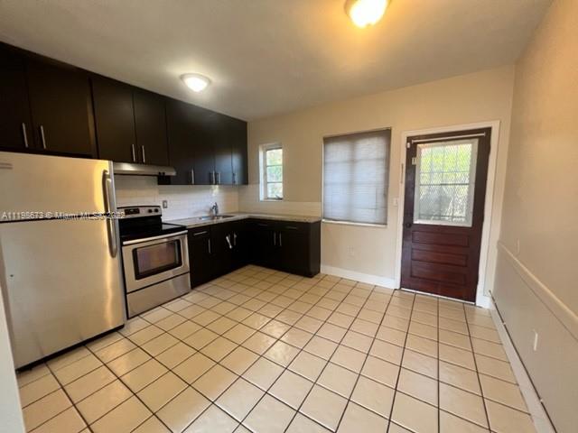 West Flagler Miami, FL 33126 - Photo 11 of 21 a kitchen with stainless steel appliances a refrigerator and a sink