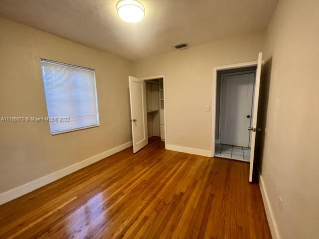 West Flagler Miami, FL 33126 - Photo 17 of 21 a view of an empty room with wooden floor and a window