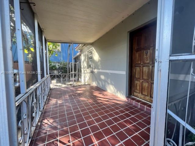 West Flagler Miami, FL 33126 - Photo 19 of 21 a view of a porch with a door and wooden floor