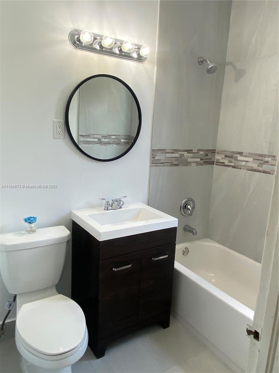 West Flagler Miami, FL 33126 - Photo 2 of 21 a bathroom with a sink mirror vanity and toilet