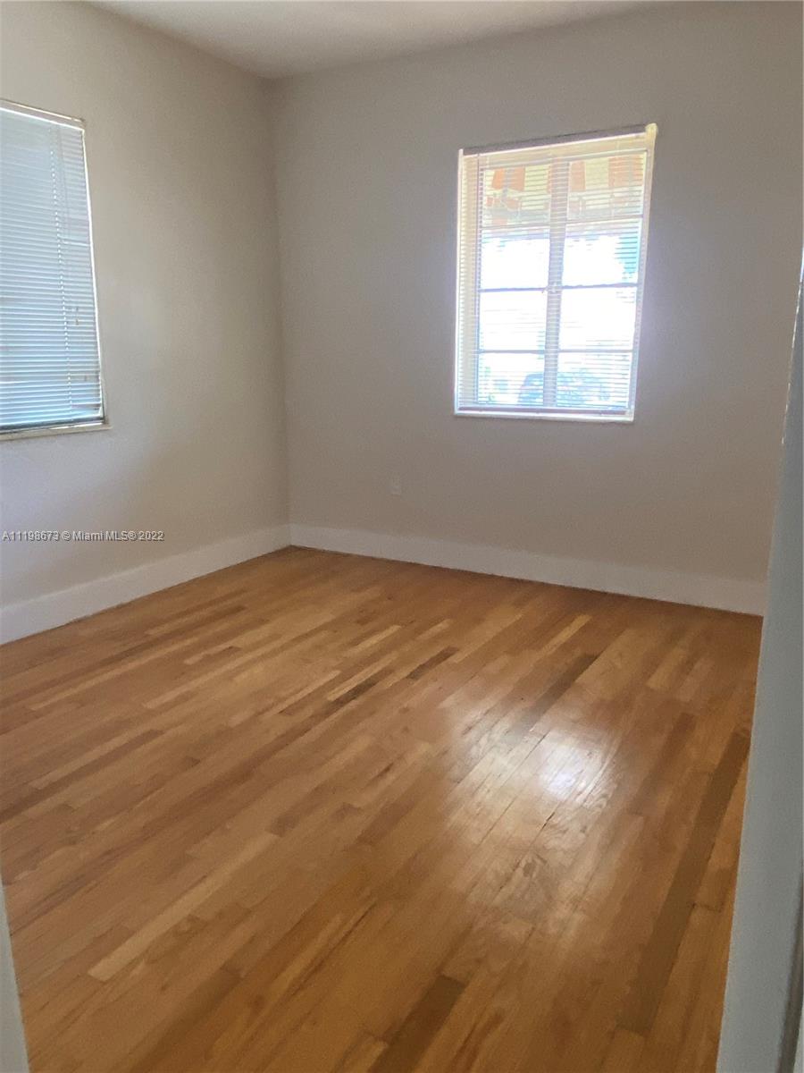West Flagler Miami, FL 33126 - Photo 3 of 21 a view of an empty room with wooden floor and a window