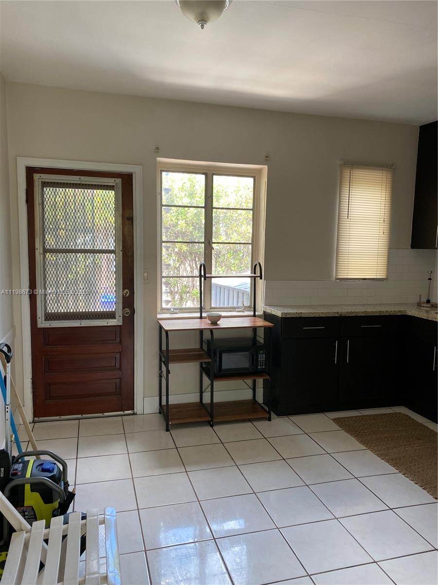 West Flagler Miami, FL 33126 - Photo 4 of 21 a kitchen with a sink and a stove top oven