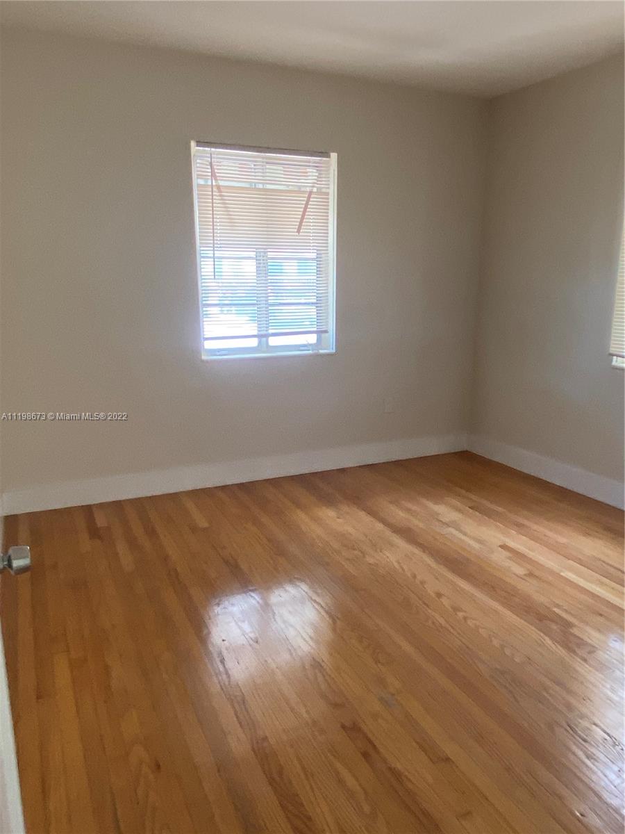 West Flagler Miami, FL 33126 - Photo 6 of 21 an empty room with wooden floor and windows