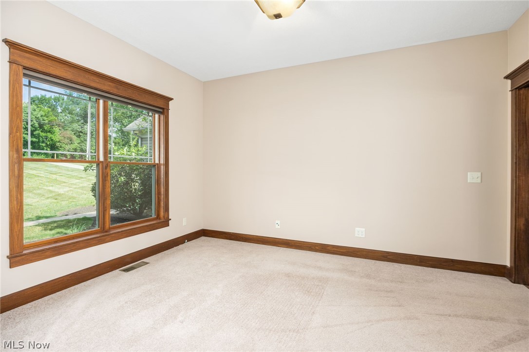 6925 River Styx Road Medina, OH 44256 - Photo 15 of 49 Bright interior space featuring a large window with wood trim, neutral wall color, and light-colored carpet