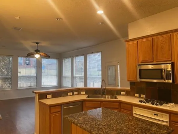 a view of a kitchen with a sink and a window
