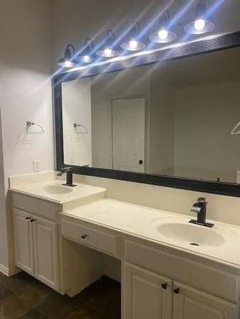 a bathroom with a sink and a mirror