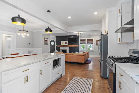 a kitchen with stove and cabinets