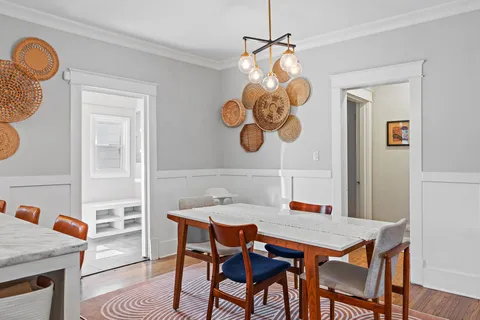 a view of a dining room with a table and chairs