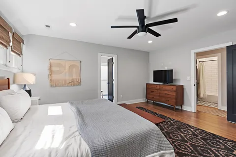 a bedroom with a bed and a flat screen tv