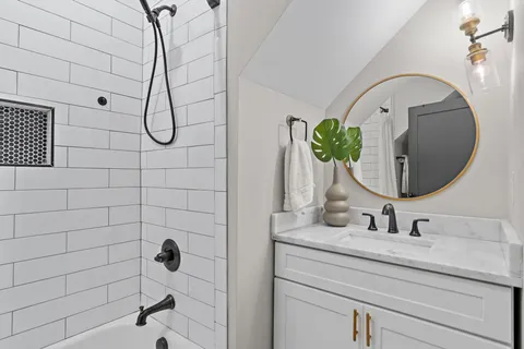 a bathroom with a sink a mirror and shower