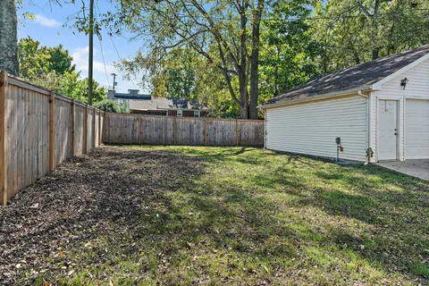 a view of small yard with wooden fence