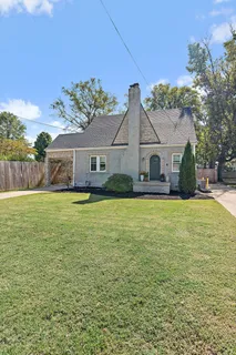 a house view with swimming pool in front of it