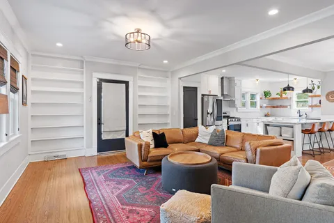 a living room with furniture and a wooden floor