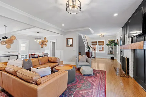 a living room with furniture a table and a large mirror