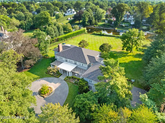 an aerial view of a house with garden space and swimming pool