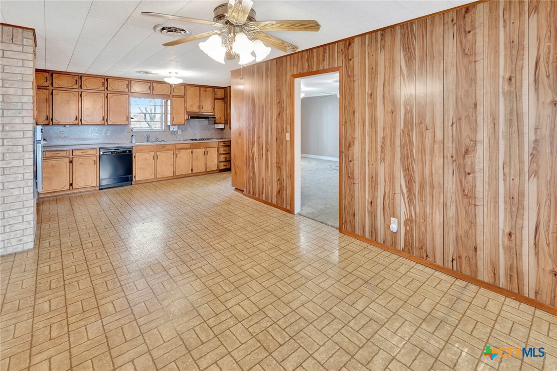 1840 Loop 522 Ganado, TX 77962 - Photo 11 of 48 an empty room with wooden floor kitchen view and a window
