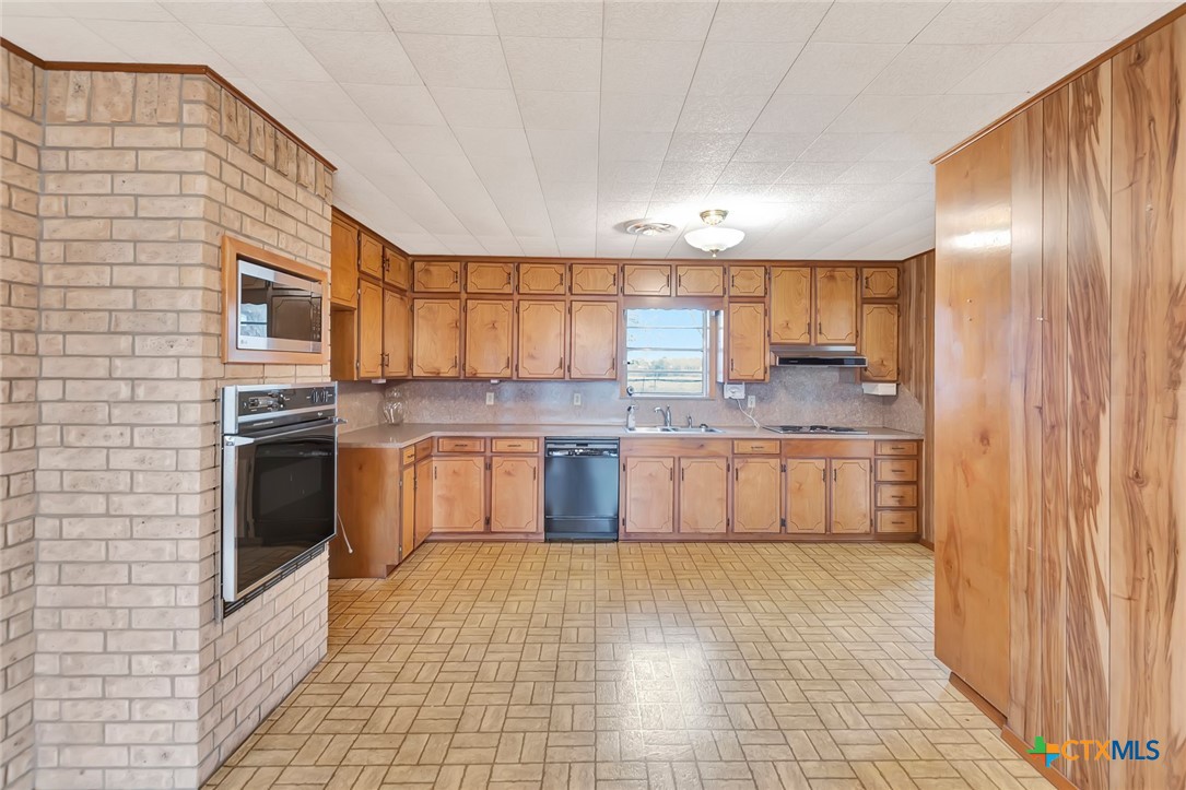 1840 Loop 522 Ganado, TX 77962 - Photo 13 of 48 a large kitchen with stainless steel appliances granite countertop a stove a sink dishwasher and a refrigerator