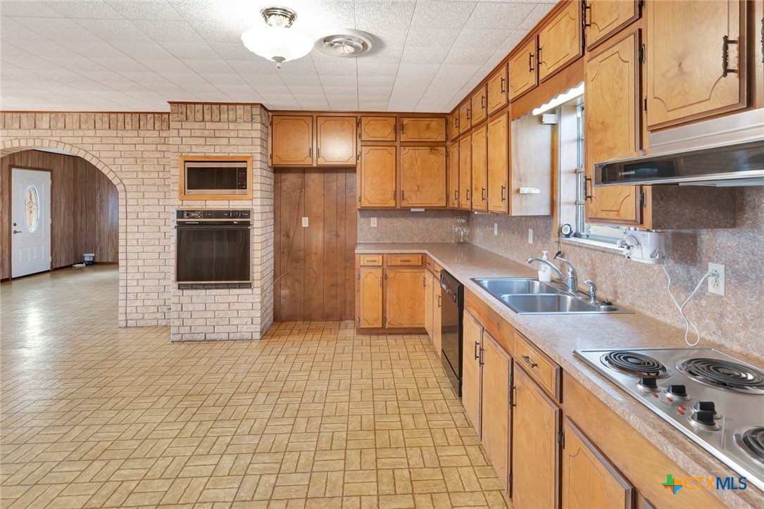 1840 Loop 522 Ganado, TX 77962 - Photo 14 of 48 a kitchen with stainless steel appliances granite countertop a sink a stove and cabinets